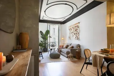a living room with a couch and a table at Bantu - 1 bedroom and balcony in Eixample Esquerra in Barcelona