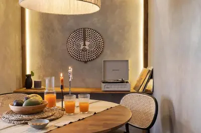 a bed with a tray of food and a drink on it at Bantu - 1 bedroom and balcony in Eixample Esquerra in Barcelona