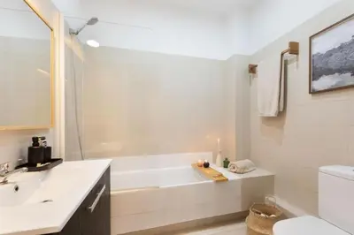 a kitchen with a white refrigerator in a room at Bantu - 1 bedroom and balcony in Eixample Esquerra in Barcelona