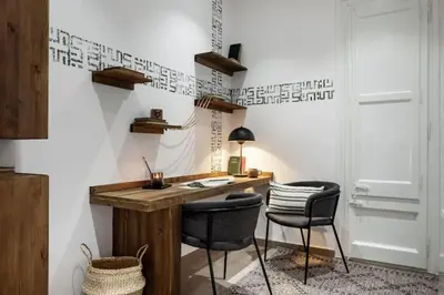 a hallway with a table with a lamp and a plant at Vili - 2 bedrooms and balcony in Sant Antoni in Barcelona