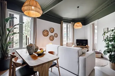 a living room with a white couch and a table at Bari - 2 bedroom and office in Sant Antoni in Barcelona