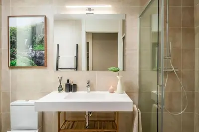 a room with a bed and a table with plants at Lulua - 2 bedrooms in Eixample Dreta in Barcelona