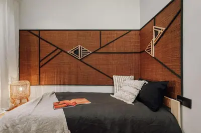 a bedroom with a large headboard and a bed at Songe - 2 bedroom in Eixample Esquerra in Barcelona