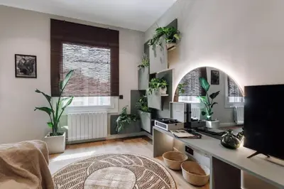 a bedroom with a bed and a large mirror at Songe - 2 bedroom in Eixample Esquerra in Barcelona