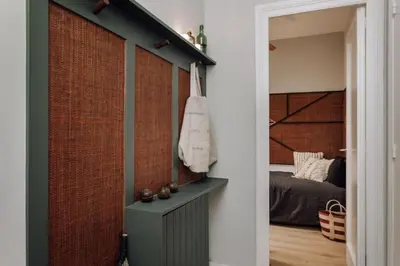 a wooden table in a room with pictures on the wall at Songe - 2 bedroom in Eixample Esquerra in Barcelona