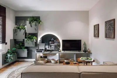 a living room with a couch and potted plants at Songe - 2 bedroom in Eixample Esquerra in Barcelona