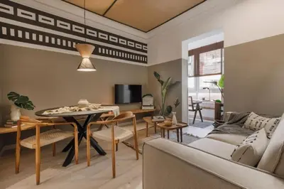a living room with a table and chairs and a tv at Bambuti - 3 bedrooms and balcony in Passeig Sant Joan in Barcelona