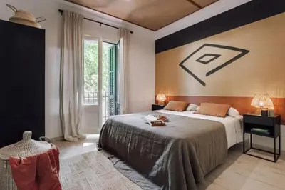 a bedroom with a large bed and two lamps at Zioba - 3 bedroom and balcony in Gracia in Barcelona
