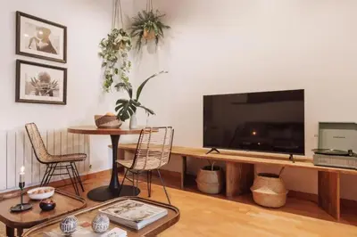 a bedroom with a canopy bed and a plant at Kakwa - 2 bedroom and balcony Eixample Esquerra in Barcelona