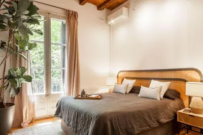 a bed with two lamps and a tray on it at Kakwa - 2 bedroom and balcony Eixample Esquerra in Barcelona