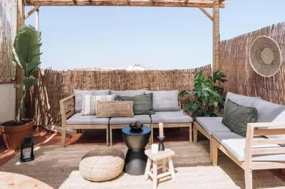 a patio with a couch and a table at Bolia - 2 bedrooms in Eixample Esquerra in Barcelona