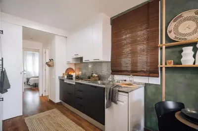 a bedroom with a large bed with a wooden headboard at Bolia - 2 bedrooms in Eixample Esquerra in Barcelona