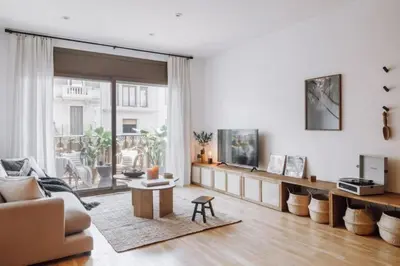 a bedroom with a wall with a mirror and a plant at Babinga - 3 bedroom and balcony in Eixample Esquerra in Barcelona