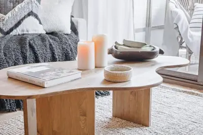 a coffee table with a book and candles on it at Babinga - 3 bedroom and balcony in Eixample Esquerra in Barcelona