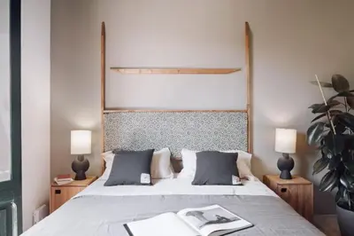 a bedroom with a bed and a potted plant at Hemba - 3 bedroom and balcony in Gracia in Barcelona