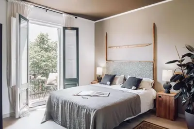 a bedroom with a large bed with two lamps at Hemba - 3 bedroom and balcony in Gracia in Barcelona