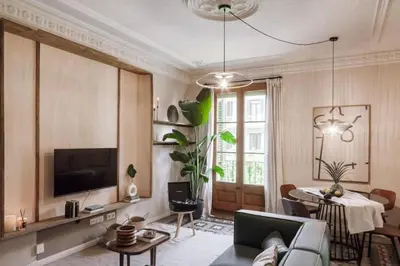 a living room with a couch and a table at Ulindi - 2 bedroom with balcony in Eixample Esquerra in Barcelona