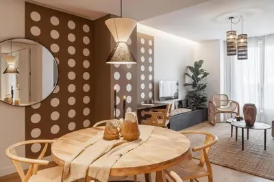 a kitchen and dining room with a wooden table and chairs at Pende - 1 bedroom and swimming pool in Passeig de Gracia in Barcelona