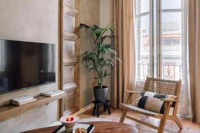 a living room with a couch and a table at Salonga - 1 bedroom and balcony in Eixample Esquerra in Barcelona