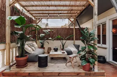 a bedroom with a large bed and a large wooden cabinet at Mwitu - 2 bedroom and balcony in Poblenou in Barcelona