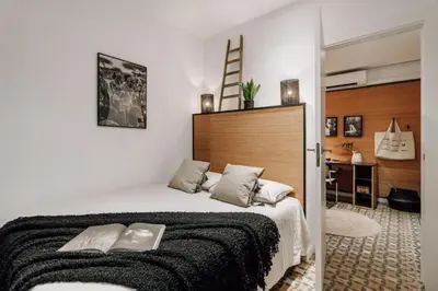 a kitchen with wooden cabinets and a table with a plant at Mwitu - 2 bedroom and balcony in Poblenou in Barcelona