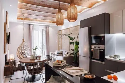 a kitchen and living room with a table and chairs at Zongo - 2 bedroom in Eixample Dreta in Barcelona