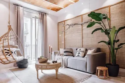 a living room with a couch and a large plant at Zongo - 2 bedroom in Eixample Dreta in Barcelona
