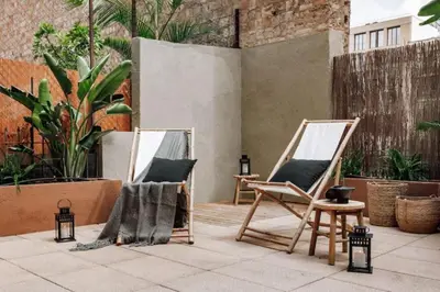 a pair of chairs and mirrors on a patio at Matadi - one bedroom and terrace in Eixample Esquerra in Barcelona