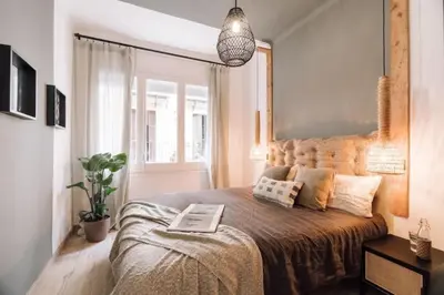 a bedroom with a large bed and a window at Kananga - 3 bedroom in Gracia in Barcelona