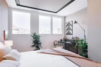 a mirror in a kitchen with a counter and a stool at Batwa - 1 bedroom in Passeig de Gracia in Barcelona