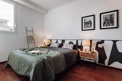 a bedroom with a bed with a black and white bedspread at Kamina - 2 bedroom in Passeig de Gracia in Barcelona