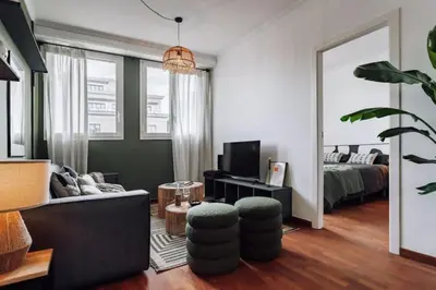 a bedroom with a bed and a green wall at Kamina - 2 bedroom in Passeig de Gracia in Barcelona