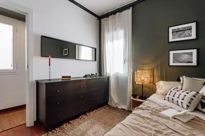 a living room with a couch and a chair and shelves at Kamina - 2 bedroom in Passeig de Gracia in Barcelona