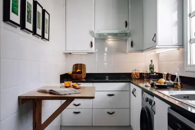 a bedroom with a bed and a chair and a window at Kamina - 2 bedroom in Passeig de Gracia in Barcelona