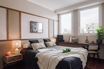a table with a bowl of fruit and candles on it at Zamba - 2 bedroom in Passeig de Gracia in Barcelona
