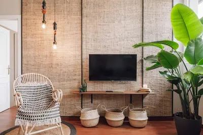 a living room with a television and a chair at Zamba - 2 bedroom in Passeig de Gracia in Barcelona