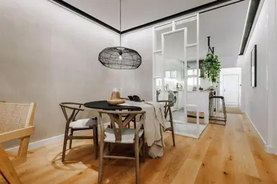 a room with a desk and stairs with potted plants at Lega - 2 bedroom in Passeig de Gracia in Barcelona