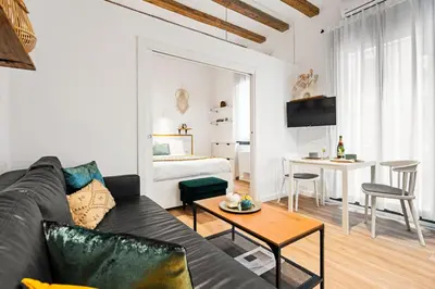 a living room with a couch and a table at Lodging Apartments Almirall Beach 11 in Barcelona