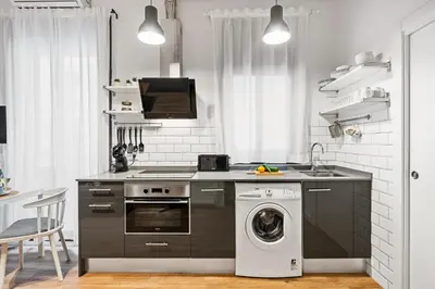 a kitchen with a stove and a washing machine at Lodging Apartments Almirall Beach 11 in Barcelona