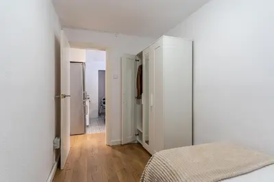 a white bedroom with a bed and a hallway at 2124 - AB Poblenou Beach Comfort in Barcelona