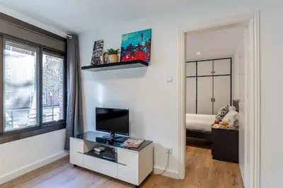 a living room with a tv on a white wall at 2124 - AB Poblenou Beach Comfort in Barcelona