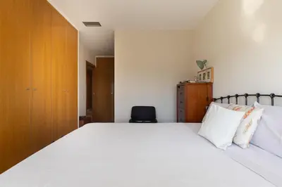 a bedroom with a large bed with white sheets and pillows at Villa Beach Barcelona in Montgat
