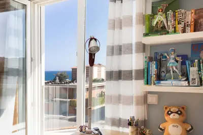 a room with a window with a teddy bear and books at Villa Beach Barcelona in Montgat