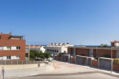 an empty street in a city with buildings at Villa Beach Barcelona in Montgat