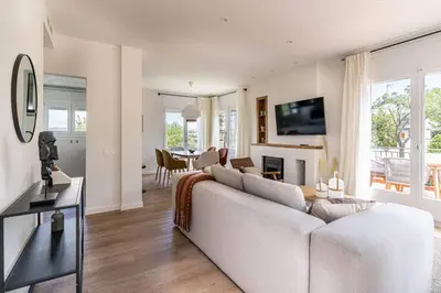 a living room with a white couch and a table at Vista Serena in Sant Cugat del Vallès