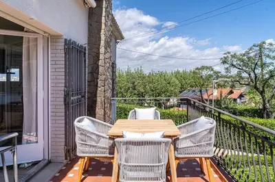 a wooden table and chairs on a balcony at Vista Serena in Sant Cugat del Vallès