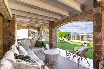 an outdoor living room with a couch and chairs at Vista Serena in Sant Cugat del Vallès