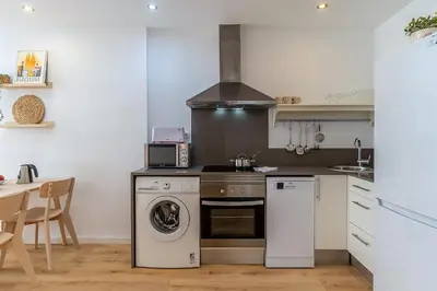 a kitchen with a stove and a washing machine at 1774 - AB Saint Joseph Apartment in Barcelona