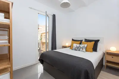 a bedroom with a large bed and a window at Cozy And Quiet In Trendy Sants in Barcelona