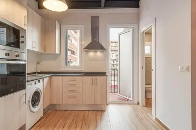 a kitchen with a washer and dryer at Live Like A Local In Eixample in Barcelona
